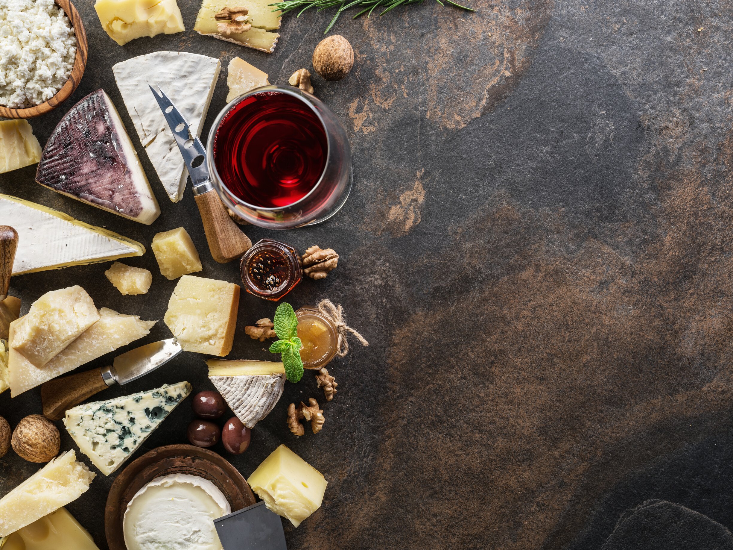 Cheese platter with organic cheeses, fruits, nuts and wine.